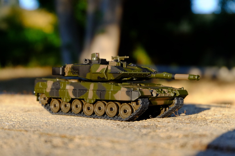outdoors, army, military, government, day, tank, toy, surface level, nature, fighting, armored tank, transportation, sign, car, aggression, war, hobbies