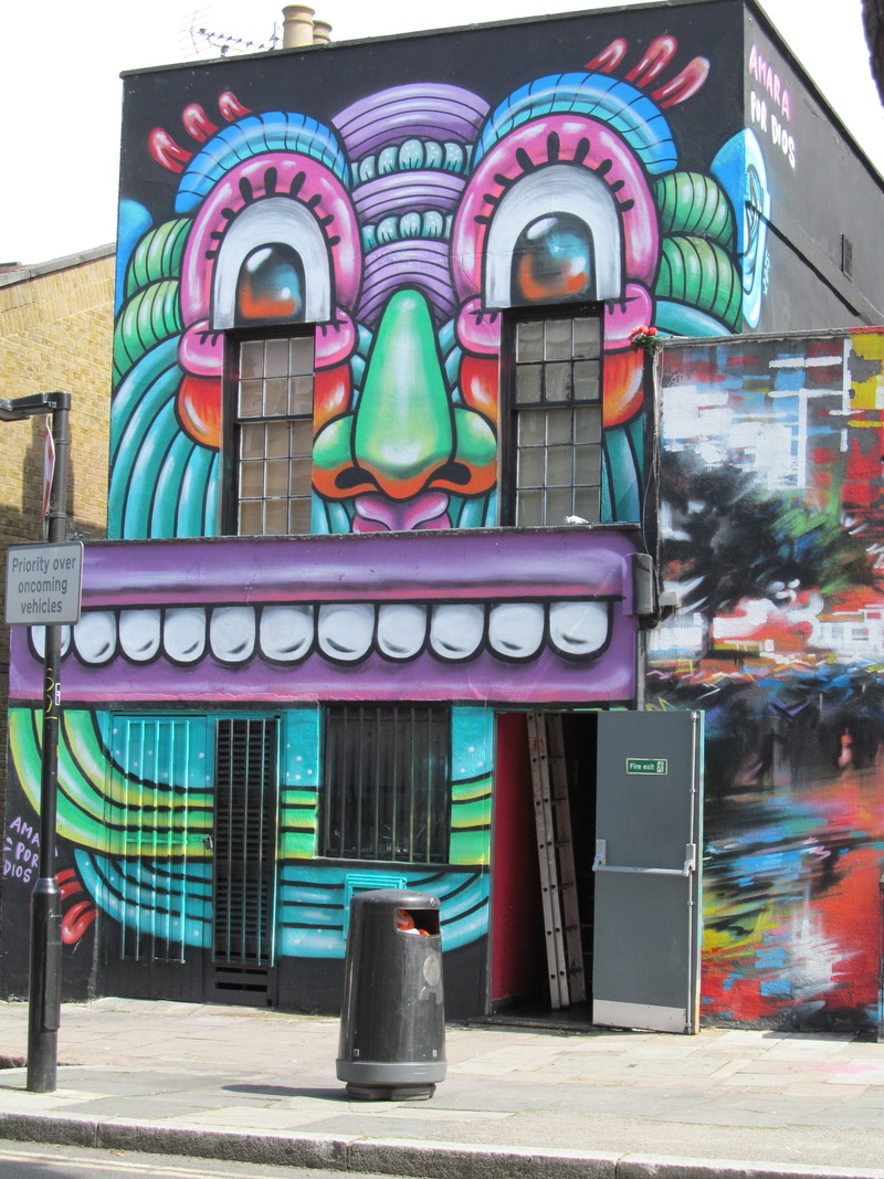 outdoors, text, building, art and craft, no people, 2K, city, human representation, creativity, building exterior, london, sign, glass - material, multi colored