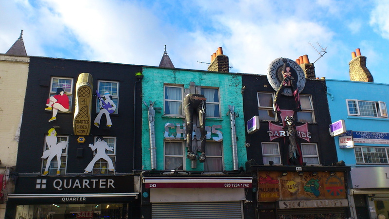 cities, male likeness, landmark, built structure, day, communication, camden town, female likeness, building, text, england, human representation, western script