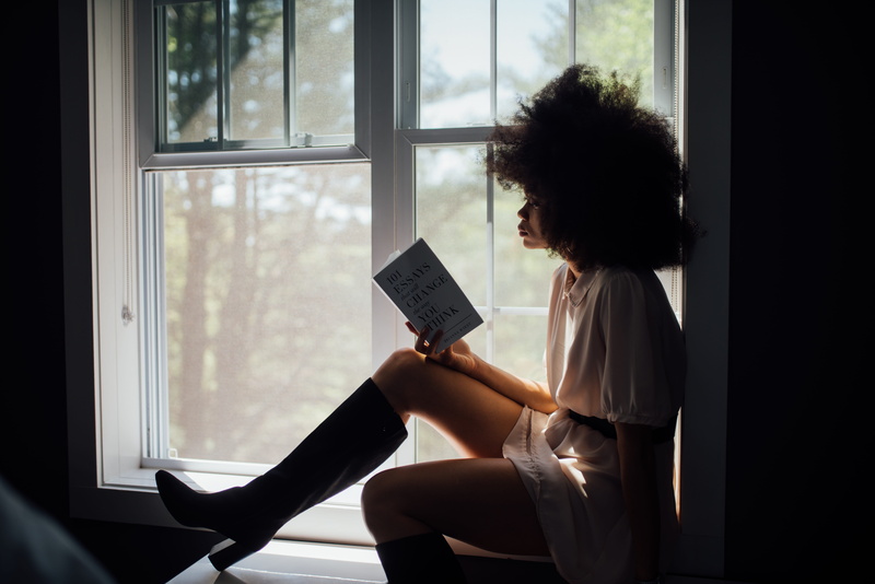 top, afro, fashion, hairstyle, black woman, 8K, sitting, emotion, glass, casual clothing, model, book, contrast, reading, interior, young adult, three quarter length