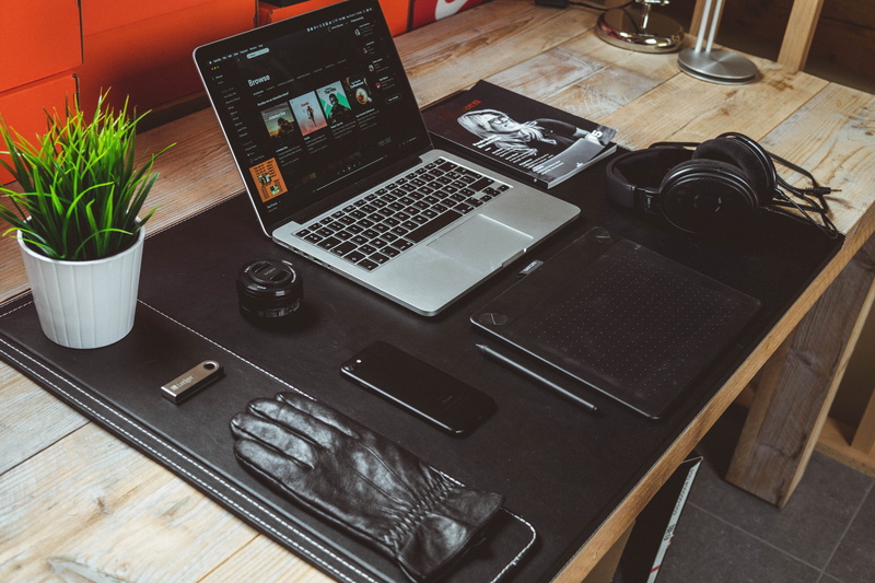 potted plant, wooden table, plants, iphone, pot, indoors, home interior, pen, magazine, glove, pro, 5K, still life, communication, display, macbook, portable information device