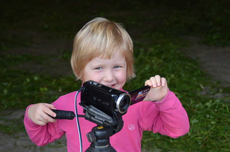 leisure activity, childhood, offspring, females, child, portrait, video camera, camera, film, looking at camera, standing, males, black, pink color, innocence