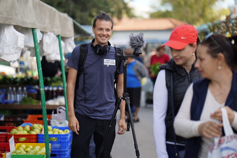 smiling, group of people, cinematographer, tourism, summer, lifestyles, men, females, three quarter length, farmers market, togetherness, people, focus on foreground