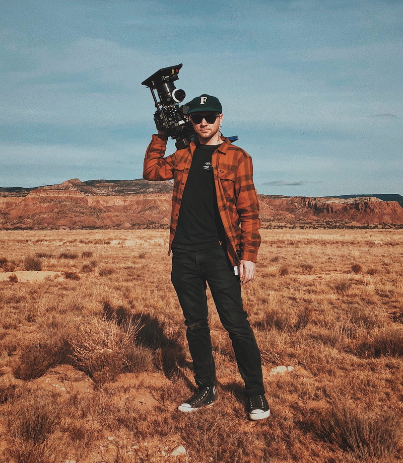 industrial, camcorder, front view, lifestyles, real people, weapon, nature, camera, clothing, black, 2K, carrying, field, man, men, cloud - sky, casual clothing