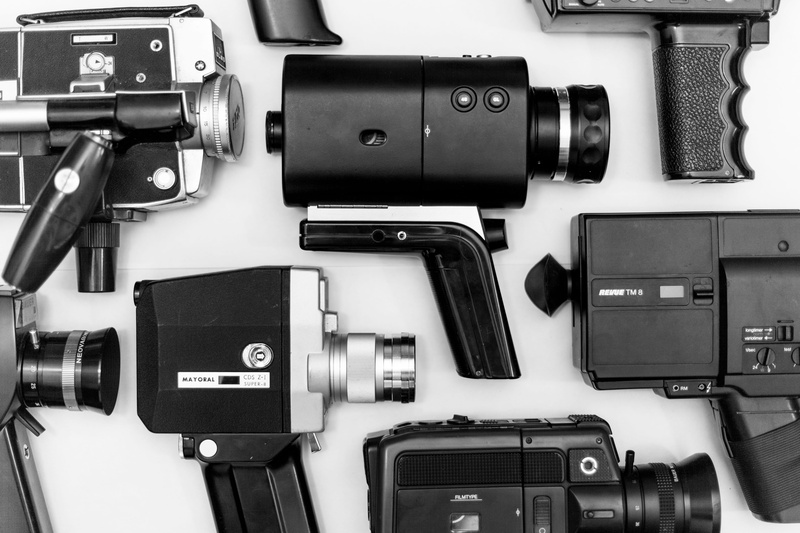 photo, black, lenses, camera, indoors, high angle view, optics, electronics, no people, cameras, table, digital camera, technology, surface, photographic equipment