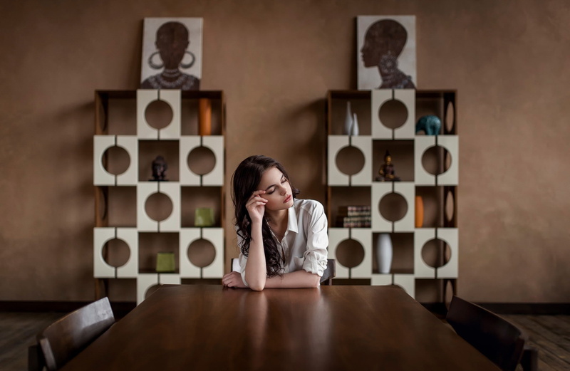 sitting, hand, women, model, emotion, table, front view, blouses, contemplation, indoors, sculpture, brunette, headshot, adult, communication, shelves