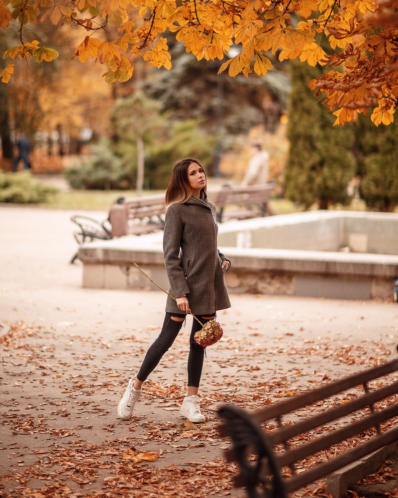 clothing, day, tree, leaves, model, outdoors, plant part, one person, young adult, coats, looking at viewer, autumn, bokeh, women outdoors, brunette, nature
