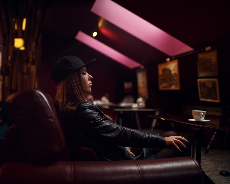 couch, model, hairstyle, one person, young adult, bokeh, sitting, black jackets, leather jacket, food and drink, contemplation, lifestyles, drink, indoors