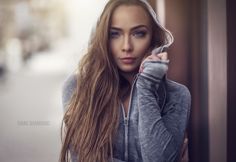 looking at viewer, portrait, straight hair, 720P, face, brunette, women, long hair, hoods, pink lipstick, zipper, touching face, Dani Diamond, blue eyes