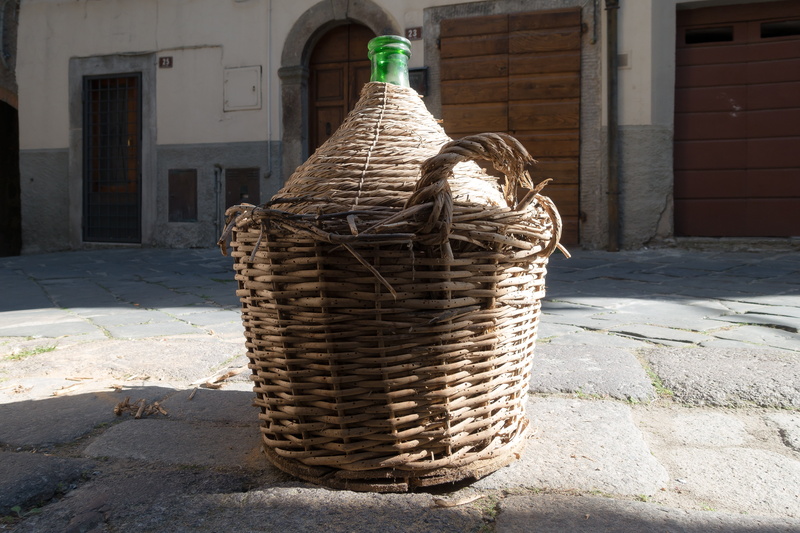 shadow, old, patch, basket, transport, wall - building feature, focus on foreground, city, wine balloon, day, container, wicker, wall, nature, antique