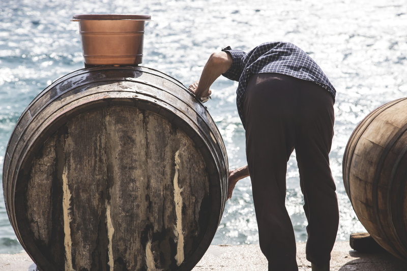 real people, wine, male, rear view, vintage, light, man, alcohol, wood - Material, person, local, ocean, old, holding, casual clothing, barrel, retired