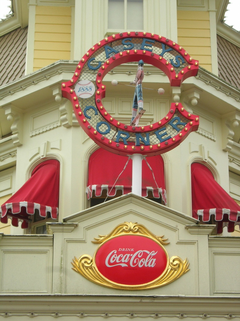 logo, coca cola, shape, communication, western script, building, built structure, red, hanging, text, time, building exterior, day, disney, clock, vintage