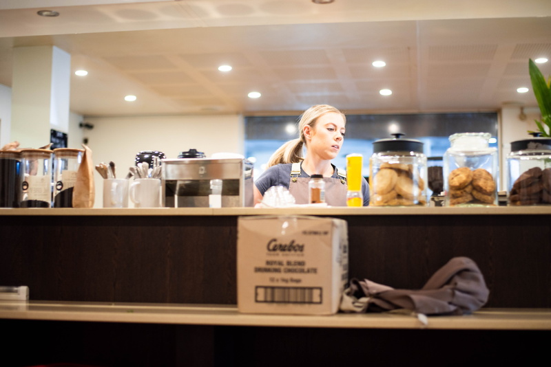 young adult, bar counter, counter, bench, illuminated, portrait, women, light, retail, cafe, hairstyle, work, jar, real people, happiness, biscuit, hair