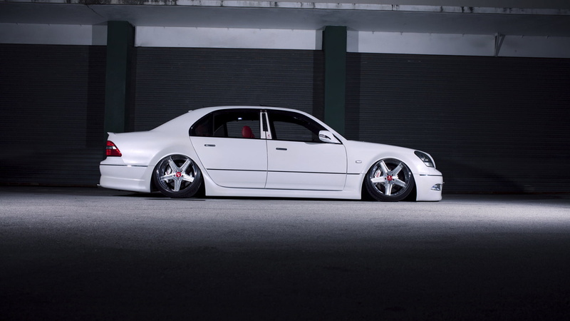 parking garage, land vehicle, indoors, motor vehicle, transportation, racecar, architecture, vip, luxury, white color, Lexus, city, day, garage, built structure