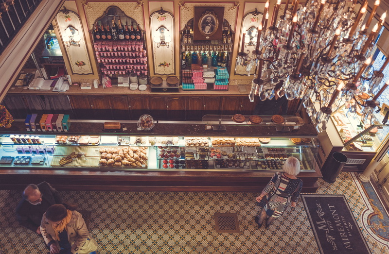 man, store, variation, no people, day, counter, beverage, choice, market, inside, sale, large group of objects, drink, cakes, standing, restaurant, pastry