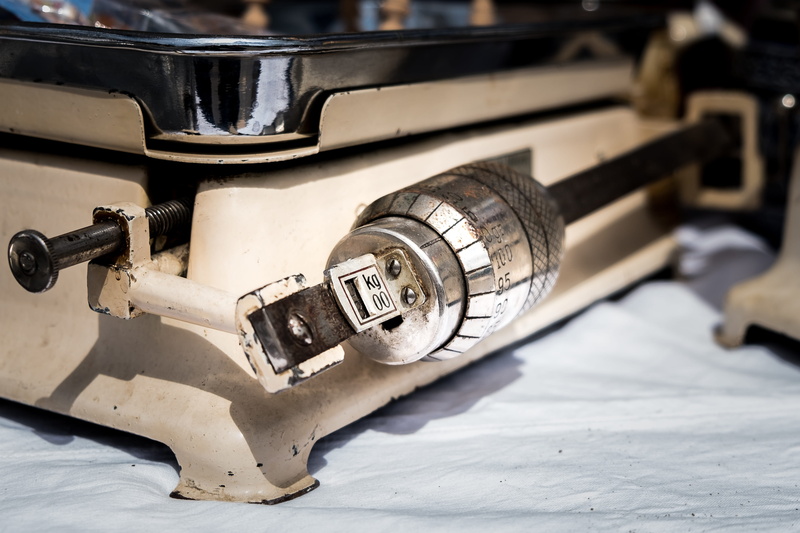 mode of transportation, gram, balance, snow, kilogram, weight, indoors, wheel, metal, unit, old, scale, land vehicle, table, focus on foreground, close-up