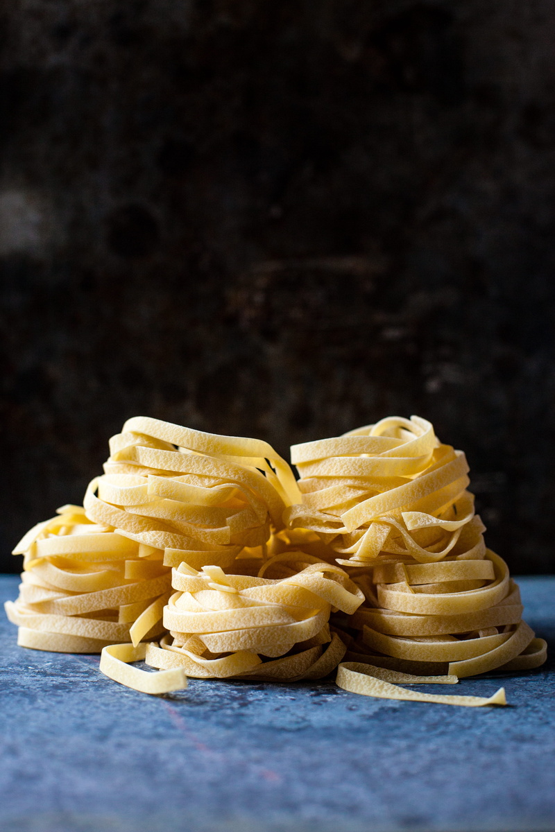 5K, copy space, no people, unhealthy eating, food and drink, black background, snack, uncooked, freshness, indulgence, pastas, stack, studio shot, ready-to-eat