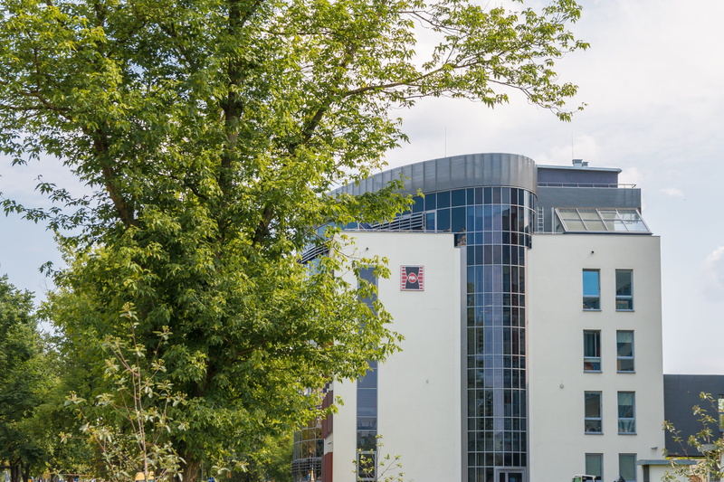 plant, glass - material, branch, polytechnic university which, low angle view, the university, building exterior, no people, sky, school, architecture