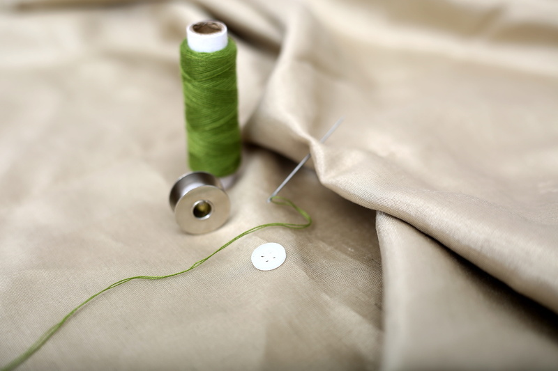 tailor, green color, color, cloth, sewing thread, indoors, skill, close-up, selective focus, fashion, accessories, spool, manufacturing, embroidery, clothing