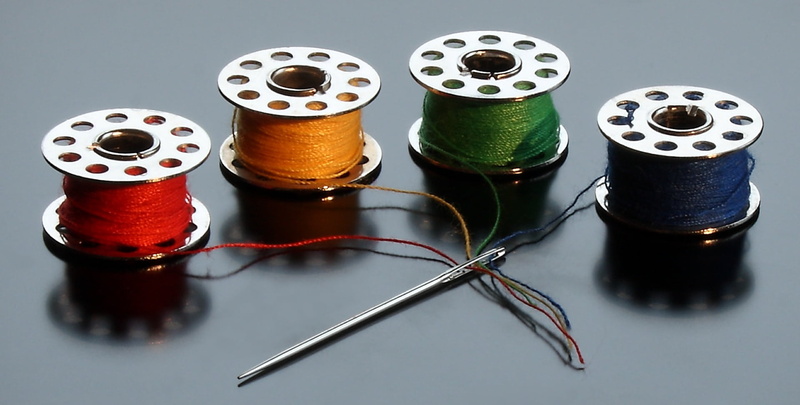 sewing, focus on foreground, thread, creativity, group, blue, yellow, high angle view, equipment, multi colored, sewing thread, silver, hobbies, industry