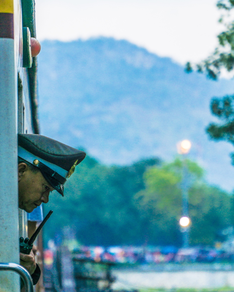 focus on foreground, human, 4K, one person, built structure, tree, hat, safety, nature, river kwai bridge, real people, person, military uniform, train