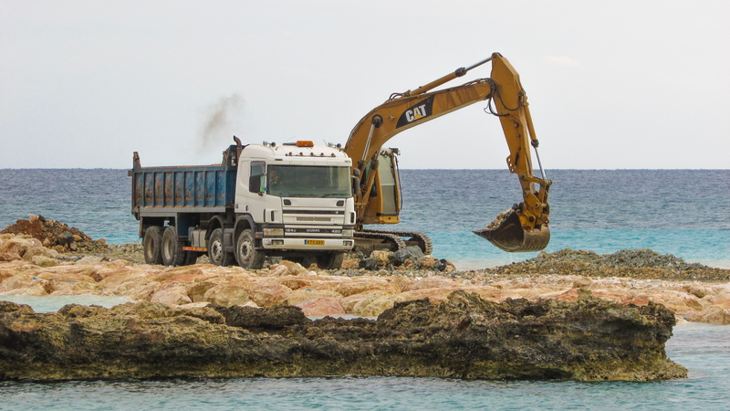 land, daytime, cat, body, heavy machines, ayia napa, excavator, rock - object, water, beach, white, working, mode of transportation, truck, dump, machinery