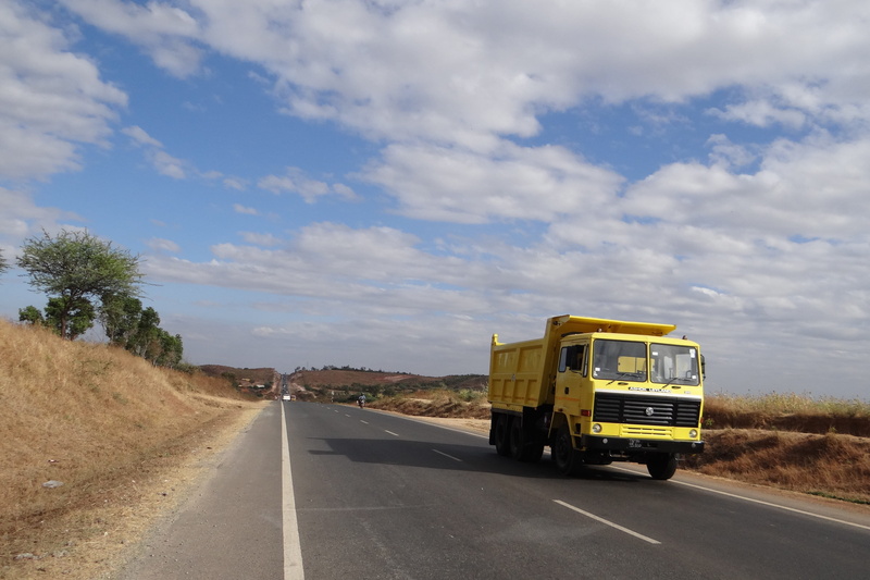 highway, cloud - sky, motor vehicle, outdoors, dividing line, sky, india, motion, symbol, sunlight, nature, day, truck, the way forward, direction, marking