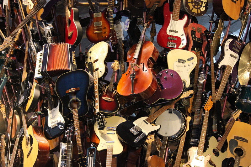 electric guitar, musical equipment, rock guitar, store, abundance, indoors, sale, string instrument, music, hanging, variation, musical instrument, stringed instrument