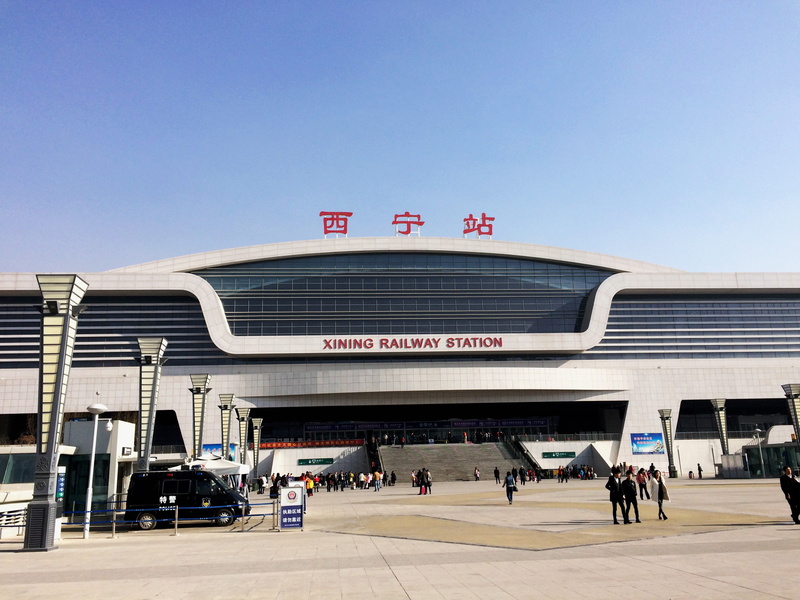 sunny, 2K, traffic, xining, outdoors, xining railway station, built structure, incidental people, adult, city, travel destinations, architecture, text