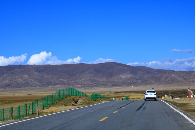 no people, mountain range, sign, day, on the move, car, qinghai, blue sky, environment, sky, china, transportation, road trip, mode of transportation, the scenery