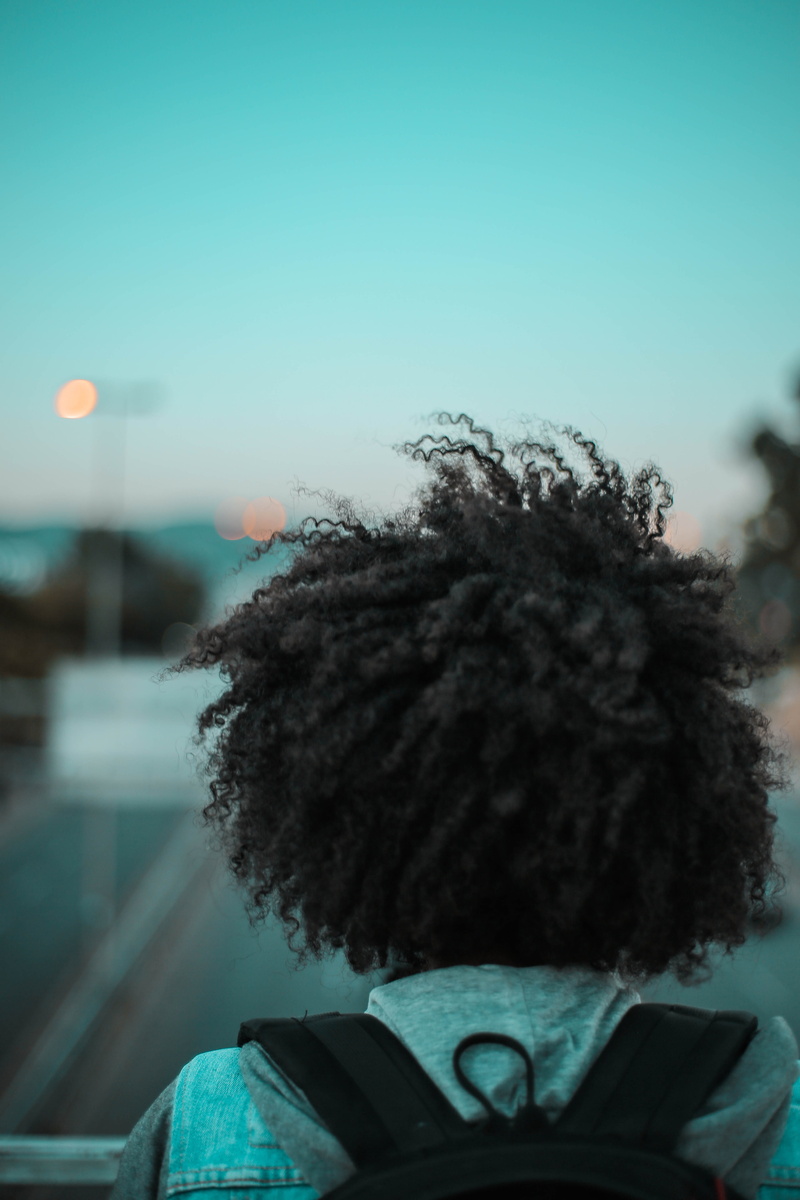 day, hairstyle, outdoors, smoke, nature, banister, sky, pollution, office building, warm clothing, one person, plant, human hair, machine, person, hair