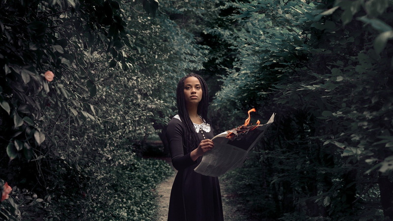 leaves, fire, young adult, ebony, adult, women, lifestyles, 1080P, waist up, black dress, tree, land, front view, long hair, standing, forest, outdoors