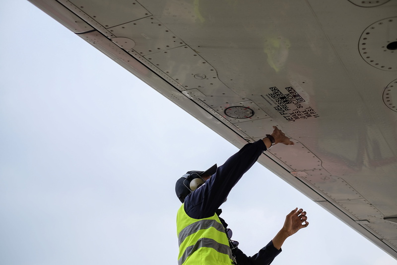 reflective clothing, one person, structure, caucasian, hand, aerospace industry, mode of transportation, airplane maintenance, air vehicle, human body part
