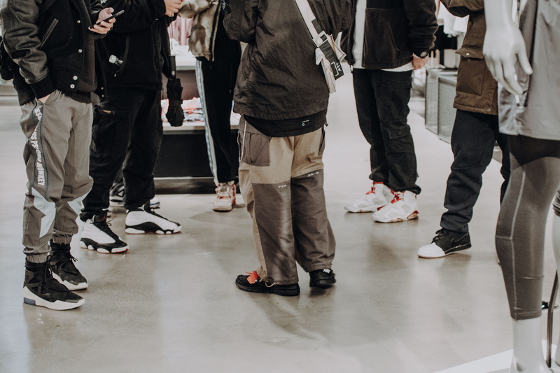 men, running shoe, festival, group of people, casual clothing, people, shoe, low section, floor, human leg, overcoat, wearing, day, human, footwear, crowd