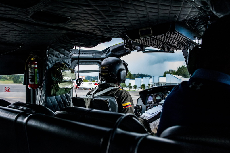 headshot, land vehicle, 1080P, people, transportation, rear view, uniform, outdoors, travel, helicopter, day, real people, vehicle seat, sitting, mode of transportation