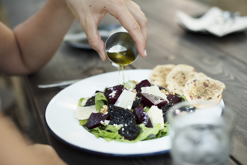 holding, selective focus, women, healthy lifestyle, dish, food and drink, food, pouring, one person, salad, plate, cheese, hand, human body part, olive oil