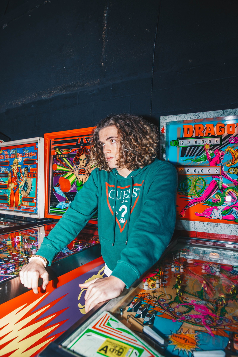 arts culture and entertainment, standing, casual clothing, 5K, clothing, arcade game machine, multi colored, apparel, shelf, one person, sweets, video gaming