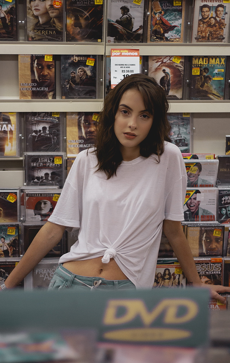commerce, hairstyle, merchandise, wearing, young women, looking at camera, stock, beautiful, person, adult, sell, standing, shelf, near, beautiful woman