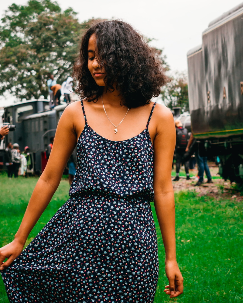 outdoors, portrait, built structure, nairobi, long hair, nature, hair, beautiful woman, waist up, black, three quarter length, casual clothing, architecture