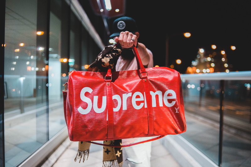 architecture, illuminated, red, retail, outdoors, shopping, bag, holding, duffel, white, city, store, one person, leather, focus on foreground, supreme