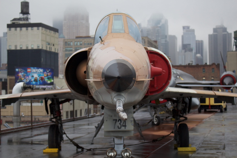 no people, airport, urban, aircraft, built structure, cloud, airplane, fighter, intrepid museum, white, beige, plane, nature, propeller, cityscape, outdoors