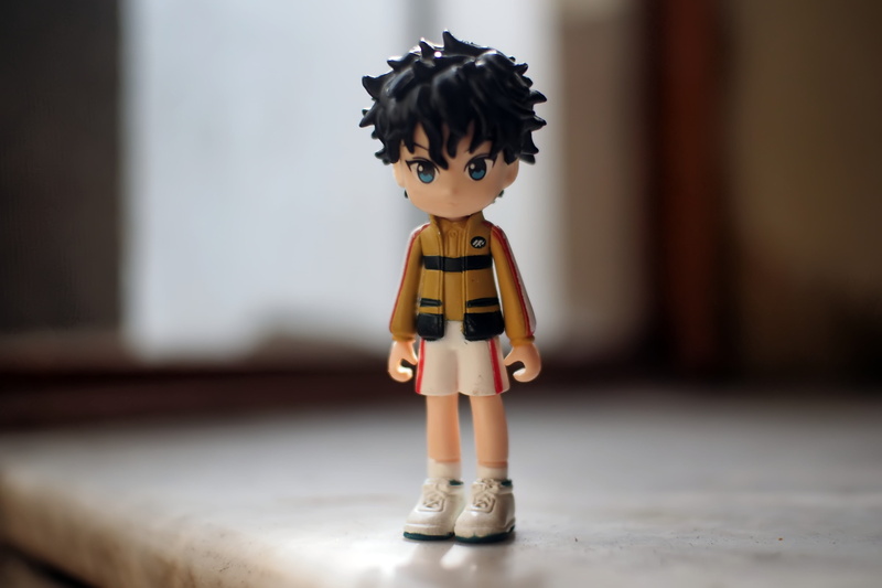robot, ryoma echizen, offspring, focus on foreground, table, creativity, boy, fun, figurine, anime, female likeness, cute, close-up, series, 4K, childhood
