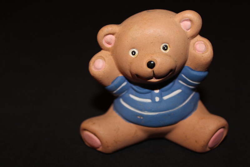 black background, Animal, broken, figurine, indoors, male likeness, food and drink, small, teddy Bear, human representation, child, people, cute, doll