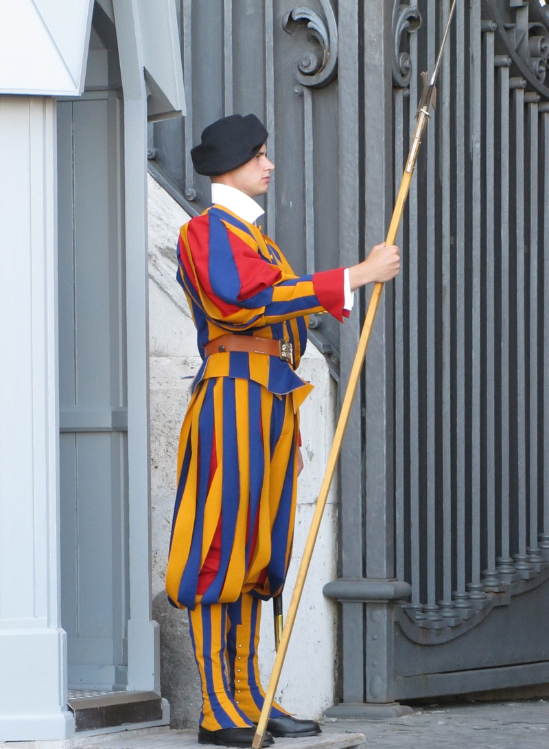leisure activity, swiss guardar, rome, catholicism, standing, real people, holding, young adult, built structure, catholic, building exterior, architecture