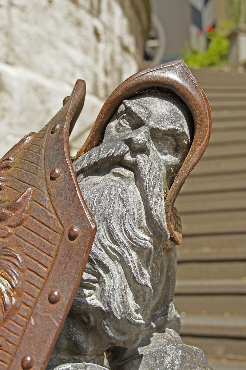 high angle view, man made object, old, head, metal, shoe, figure, architecture, outdoors, bart, focus on foreground, shield, day, still life, art and craft