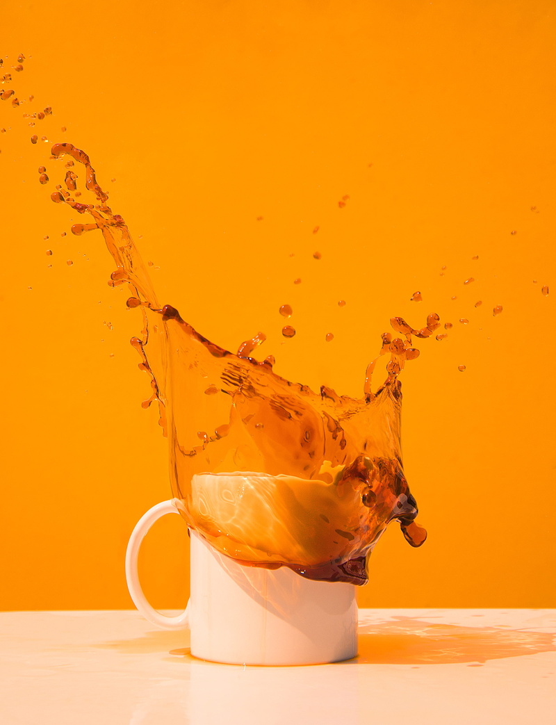 cup, tea, motion, non-alcoholic beverage, coffee cup, impact, drink, goblet, stain, high-speed photography, saucer, close-up, droplet, orange background