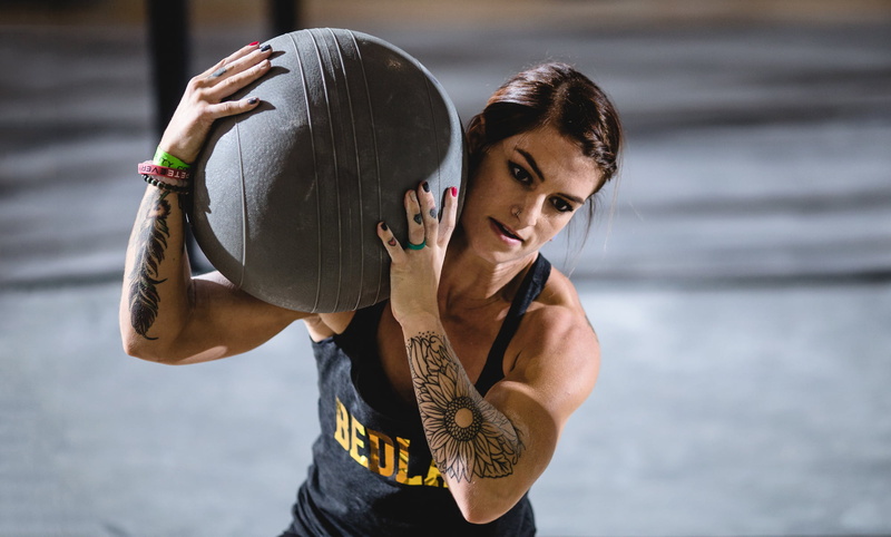 crossfit, standing, effort, real people, exercising, healthy lifestyle, one person, clothing, athlete, focus on foreground, tattoos, young women, sport