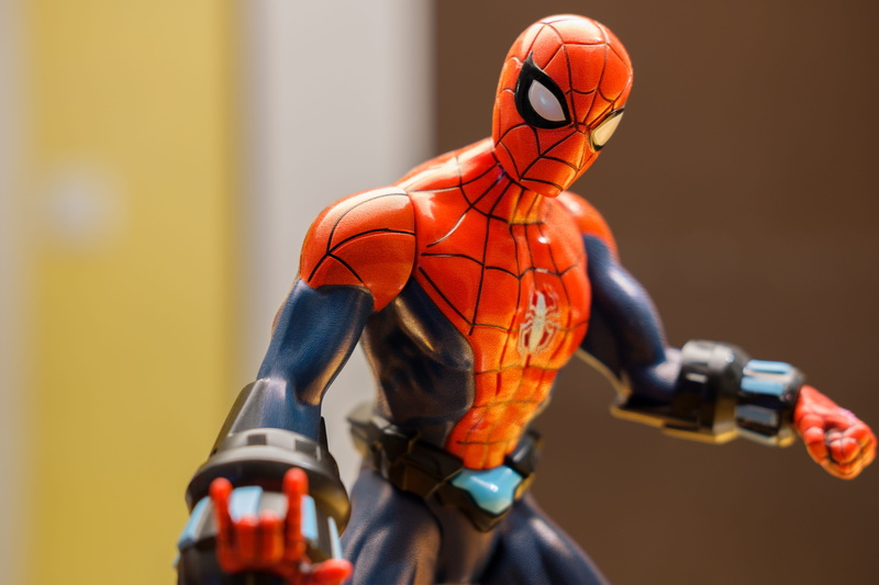 helmet, headwear, play, competition, toys, sports equipment, collector, indoors, spiderman, sports glove, action hero, front view, adult, focus on foreground