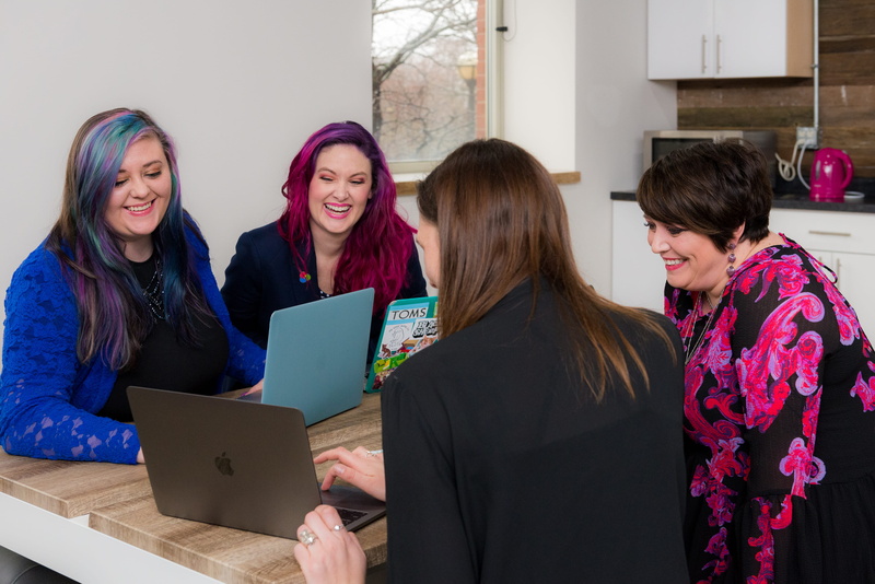 display, table, four, pc, laptops, friendship, sitting, ceo, women, monitor, young women, adult, laptop, unique, wooden, togetherness, communication, smiling