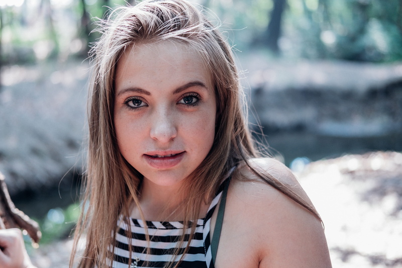 hairstyle, halter, headshot, people, apparel, one person, outdoors, leader, striped, top, fearless, looking at camera, day, long hair, woman, white, front view